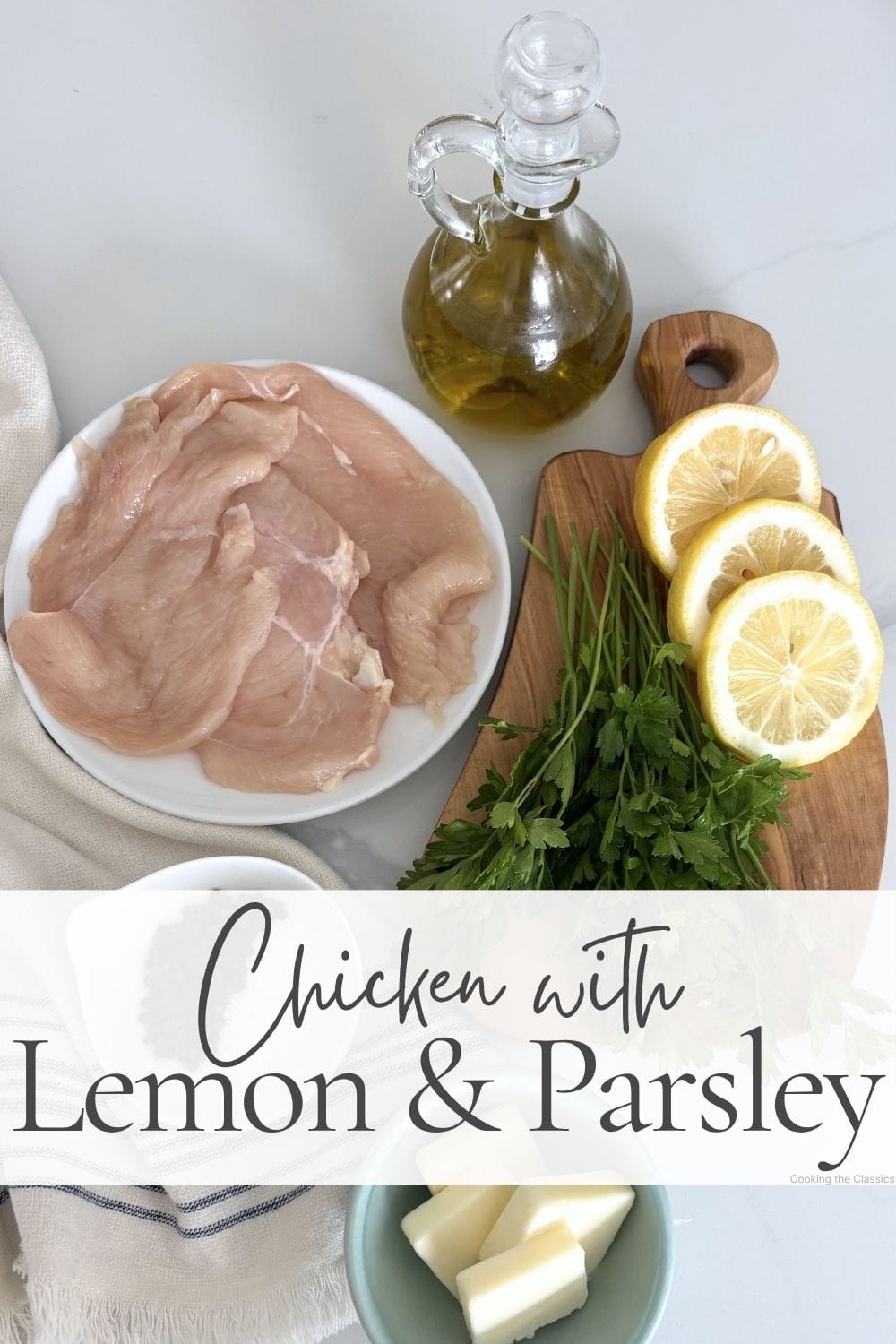 Raw chicken breasts, olive oil, lemons, parsley, and butter arranged on a marble surface with text overlay reading Chicken with Lemon and Parsley.