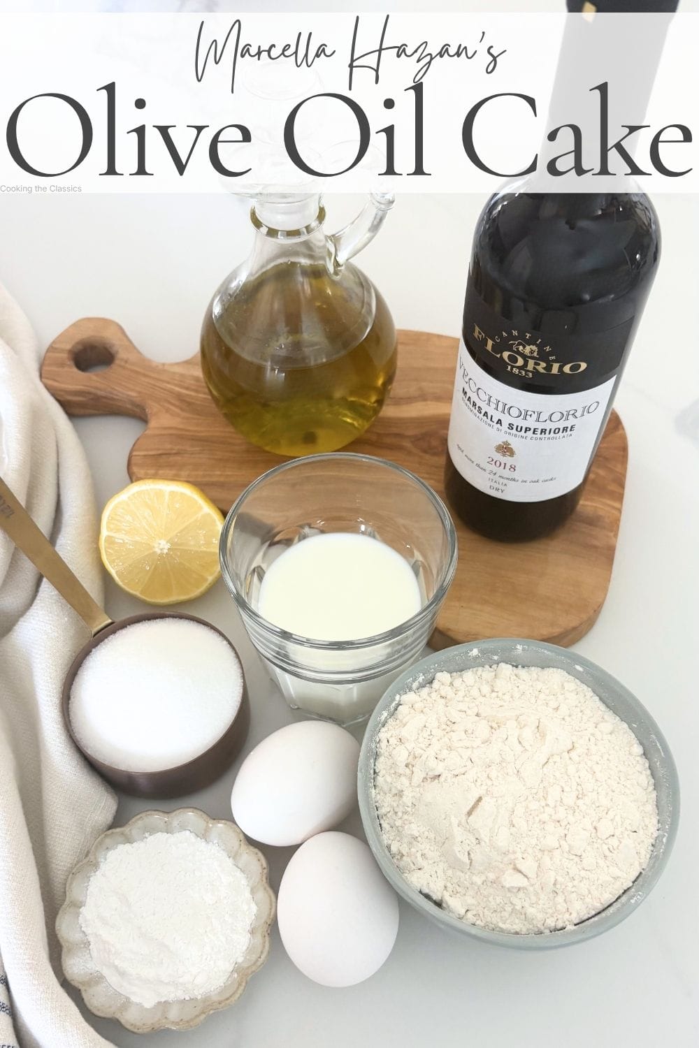 Ingredients for Marcella Hazan olive oil cake including flour, eggs, sugar, milk, lemon, olive oil, and dry Marsala.