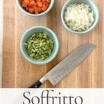 Chopped onion, carrot, and celery in bowls on a cutting board for soffritto