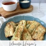 Pinterest graphic for Marcella Hazan’s Fried Zucchini paired with Prosecco featuring crispy fried zucchini slices on a blue plate.