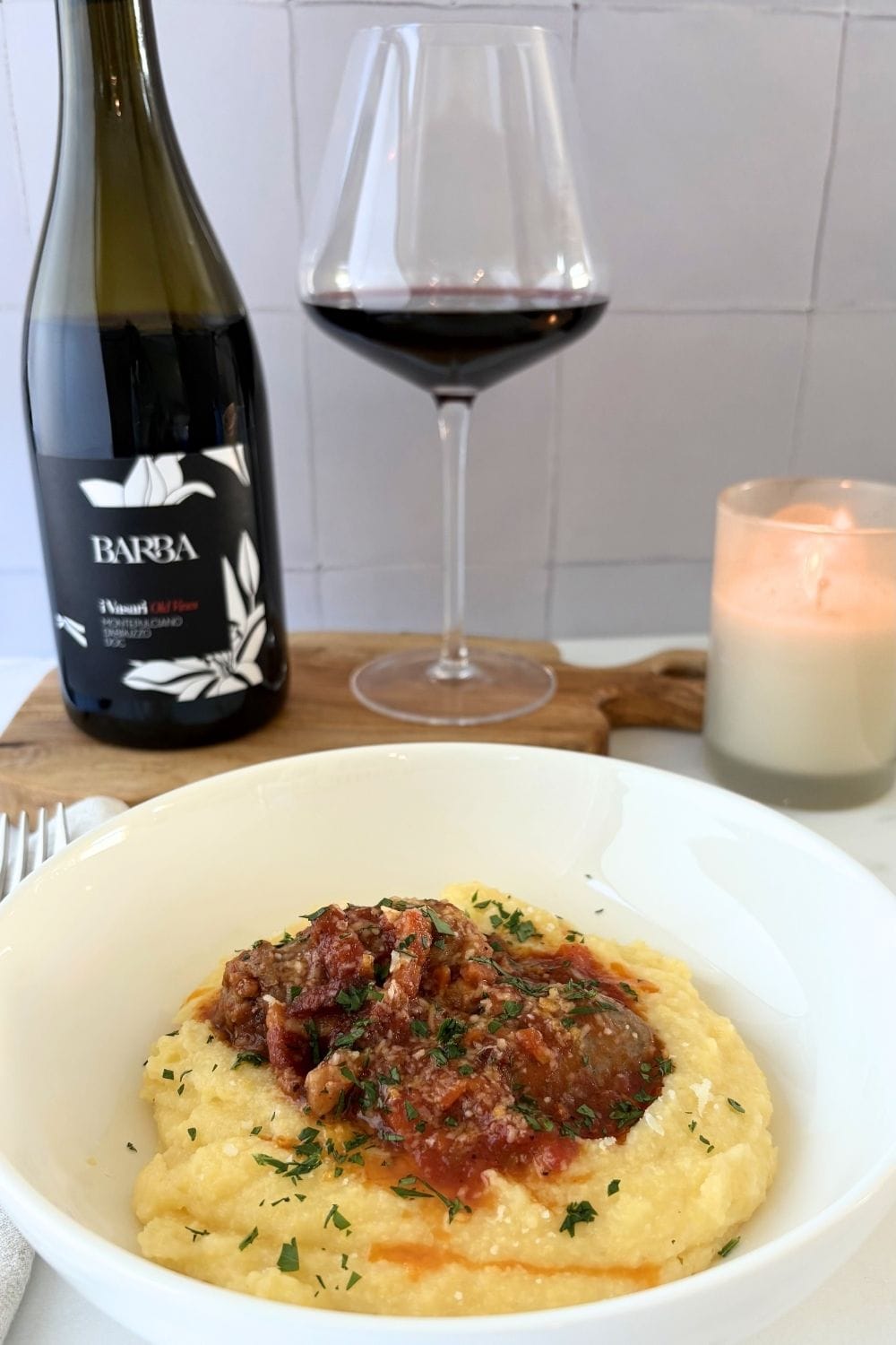 Polenta with sausage and tomato sauce served with a glass of Montepulciano d’Abruzzo