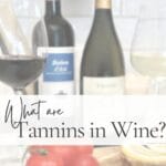Wine guide graphic titled “What are Tannins in Wine?” featuring red and white wine bottles, wine glasses, tomatoes, and lemons on an olive wood board with a soft white text overlay.