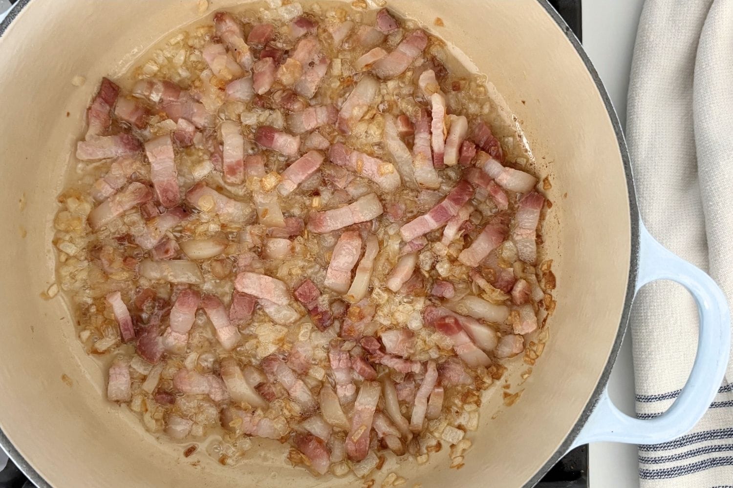 Diced pancetta and onions cooking in oil and butter for Marcella Hazan's Amatriciana sauce.
