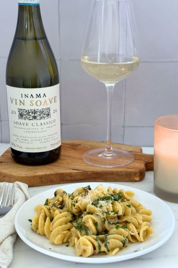 Fusilli with creamy zucchini and basil sauce served with Soave Classico, garnished with grated Parmesan and chopped fresh basil.