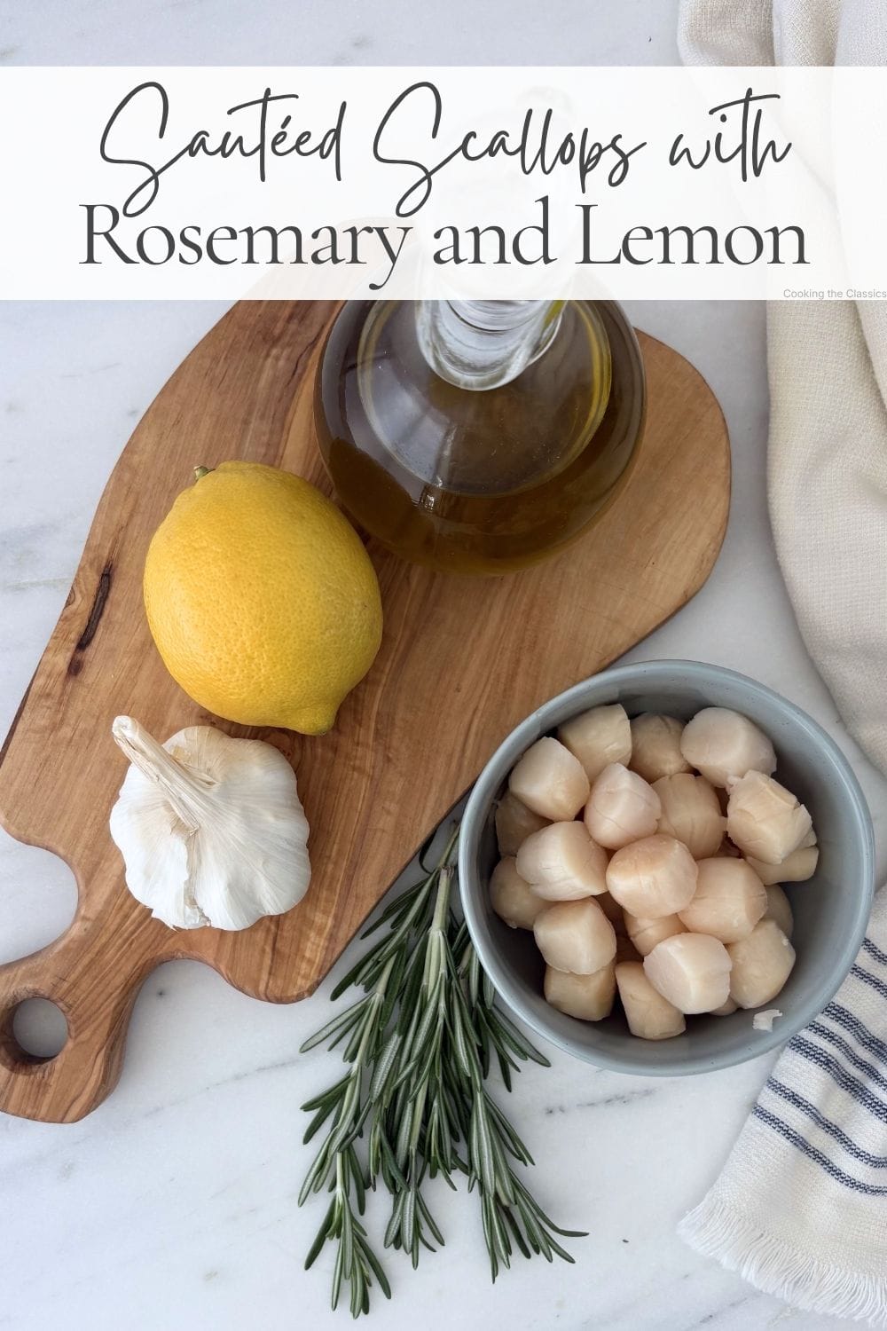 Fresh scallops, garlic, lemon, rosemary, and olive oil arranged on a wooden board.