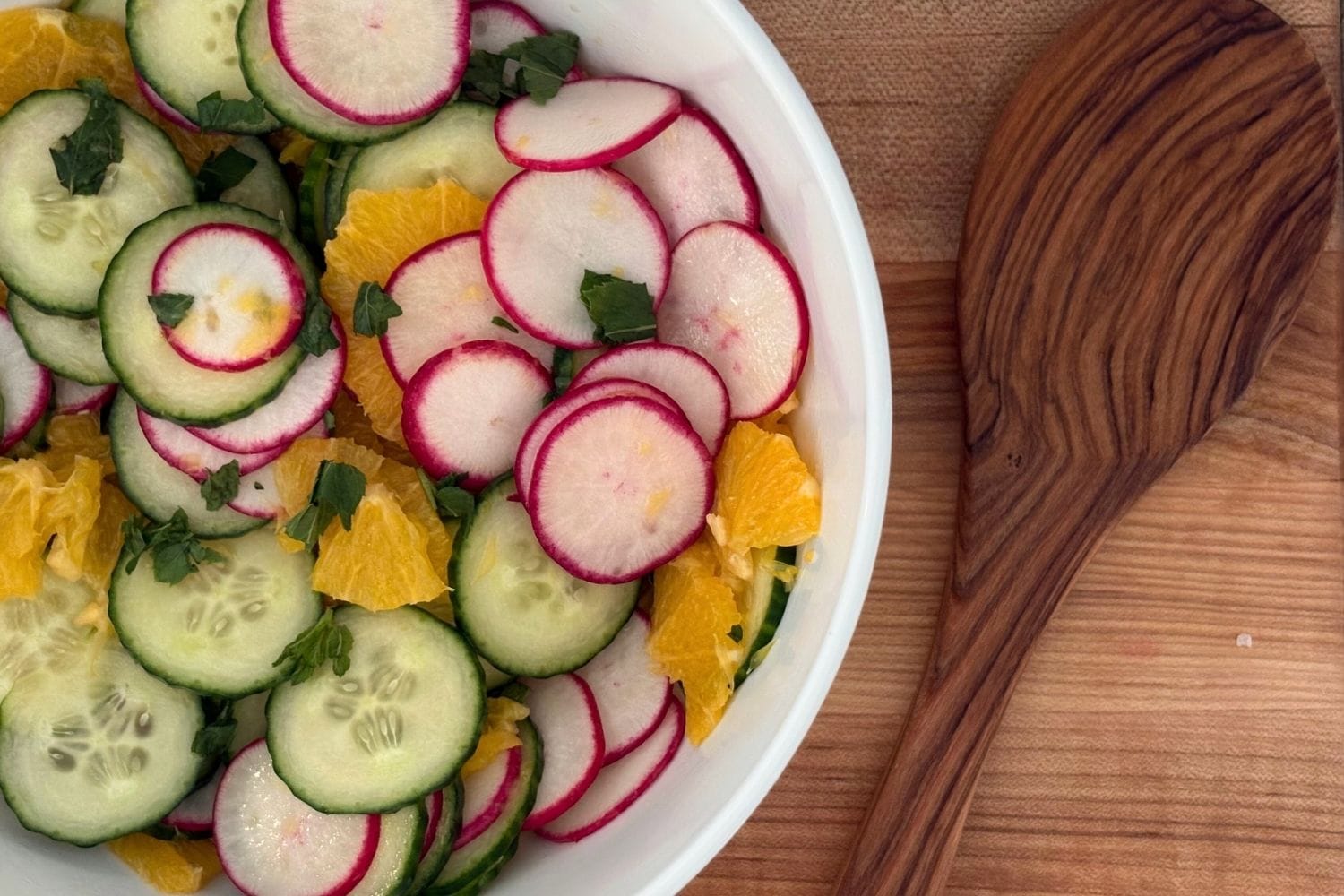 Orange and cucumber salad with thinly sliced radishes, English cucumber, fresh orange, and mint.