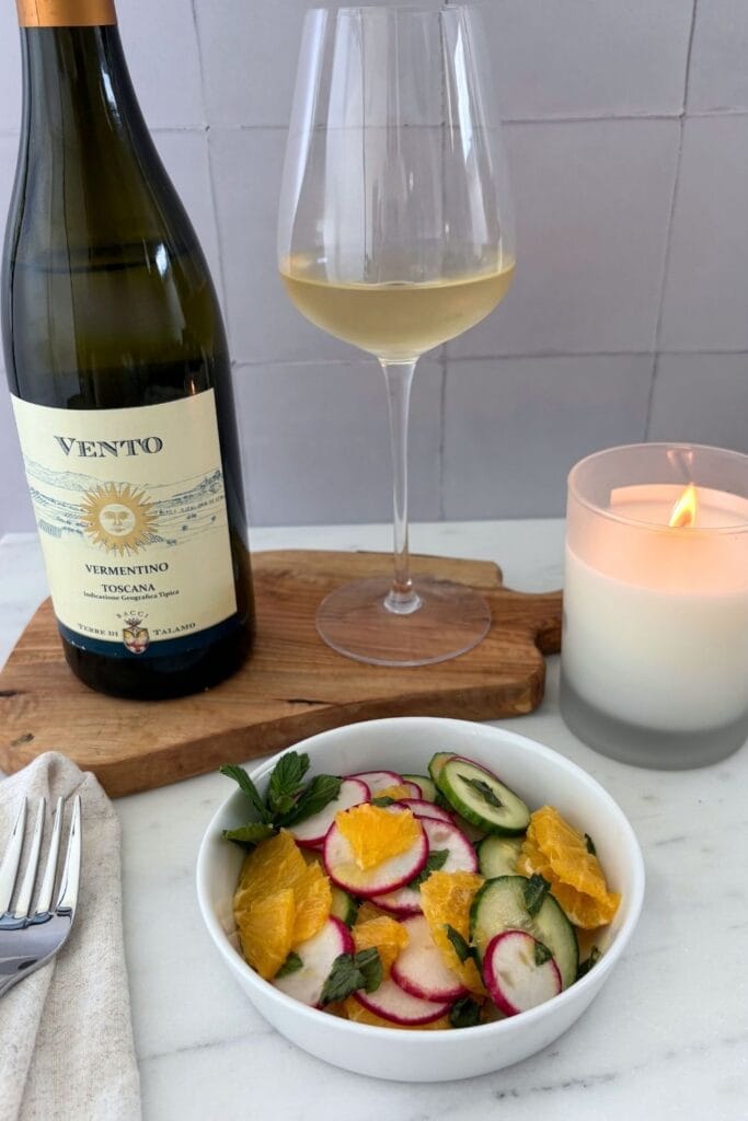 Marcella Hazan’s orange and cucumber salad with radishes and mint served with a glass of Vermentino.