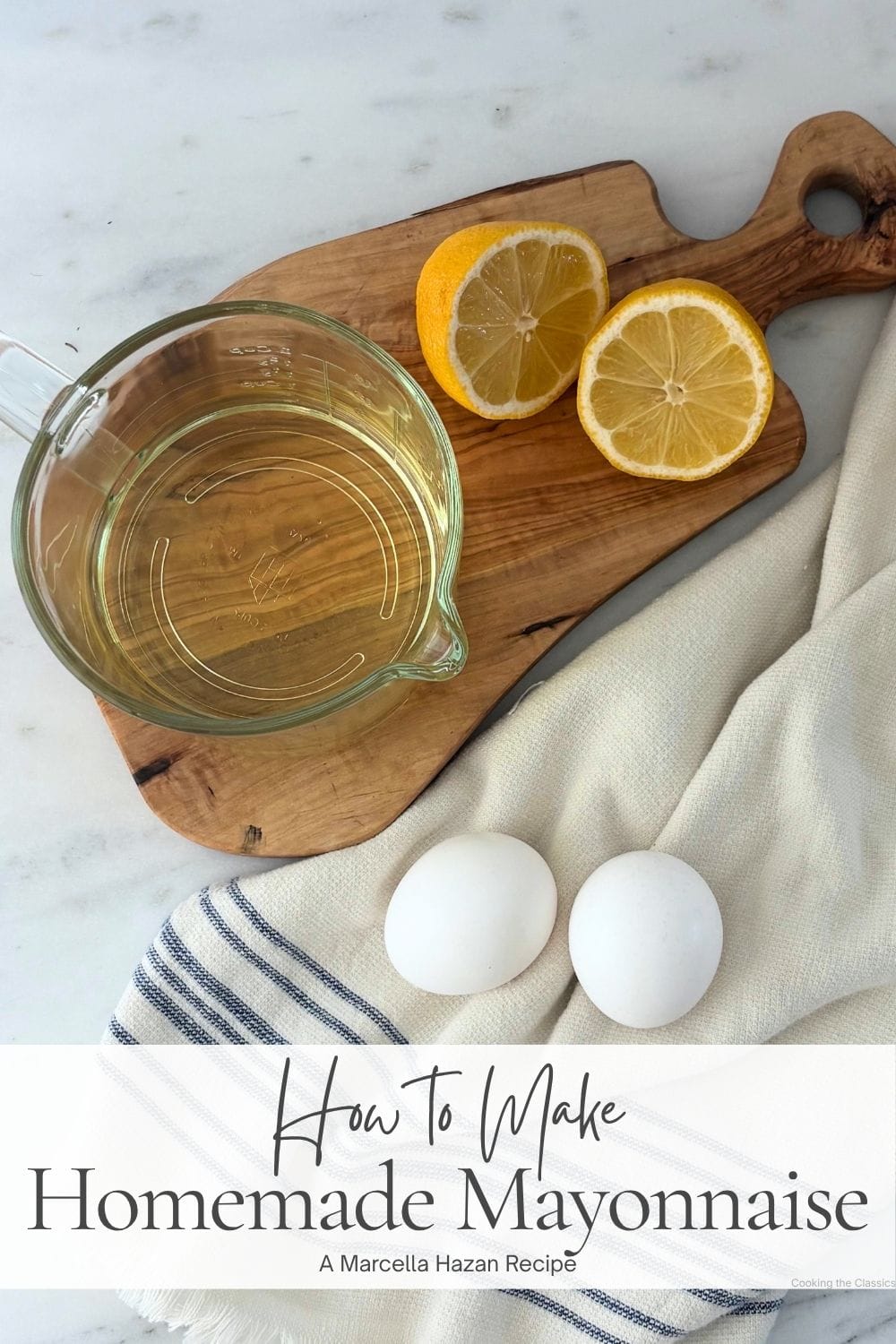 Eggs, lemon, and vegetable oil arranged on an olive wood board for making homemade mayonnaise.
