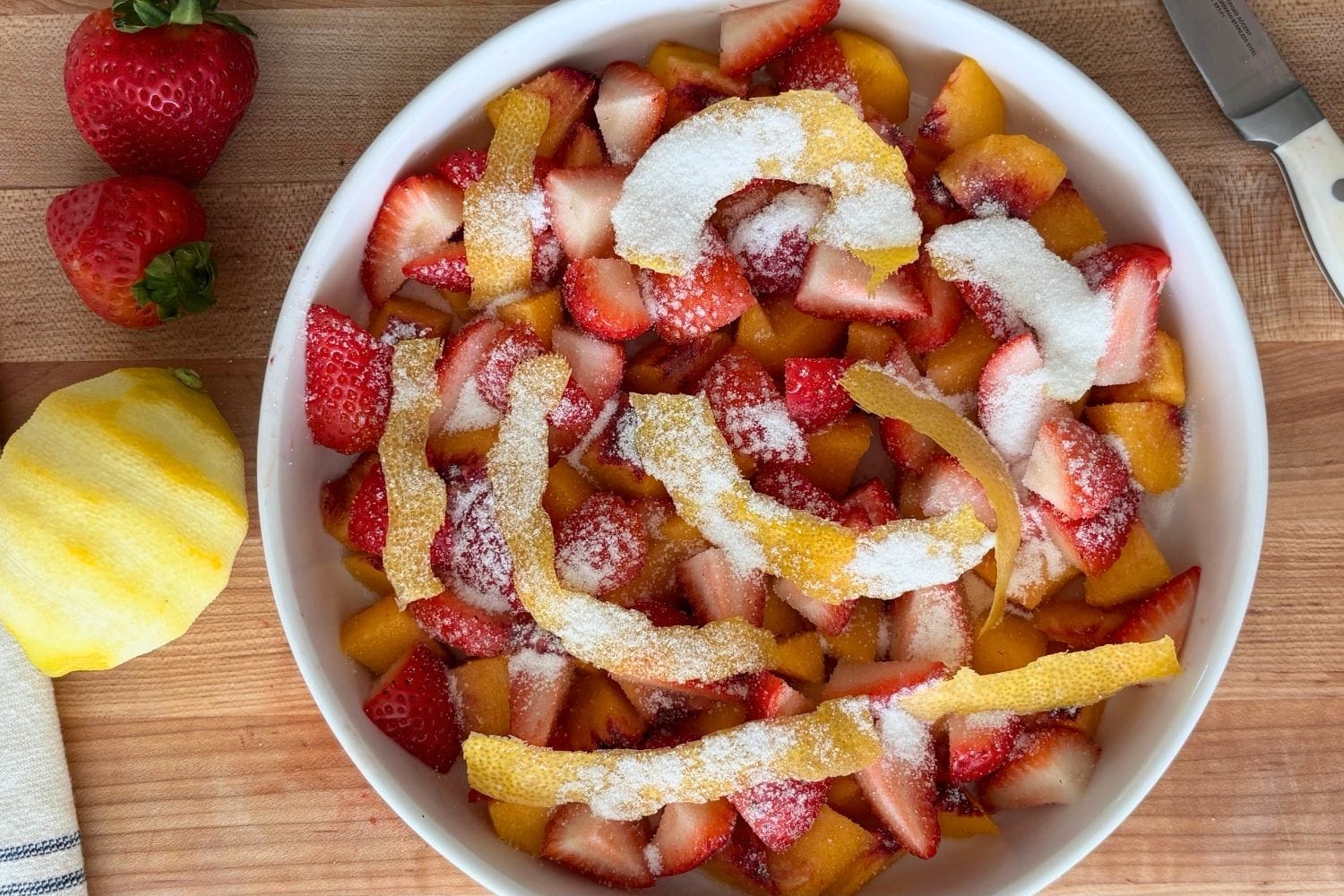 Marcella Hazan's Three Ingredient Tomato Sauce Sliced peaches and strawberries topped with sugar and strips of lemon peel before being macerated in sweet white wine.